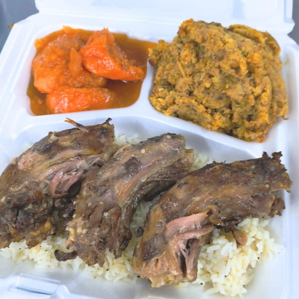 Jaguar's Spot American cuisine: ribs over rice, with candied yams and cornbread dressing in a takeout container.